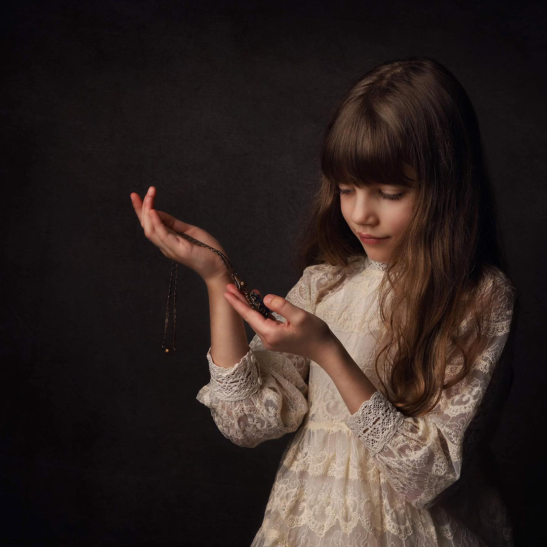 Girl holding antique jewelry